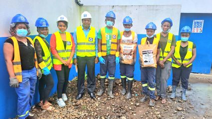Construction workers in safety vests posing together with shovels during groundbreaking ceremony