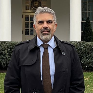 Chan Harjivan standing outdoors in front of building