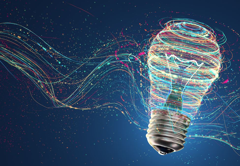 Light bulb with colorful flowing data streams against dark blue background