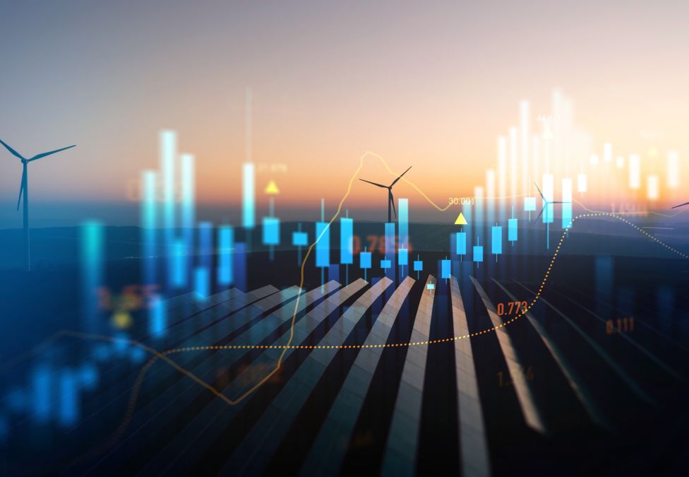 Wind turbines on farmland at sunset with glowing city skyline overlay