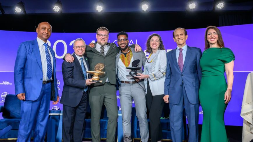 The Milken-Motsepe Innovation Prize Program team posing with Mike Milken on stage after panel at Global Conference 2024