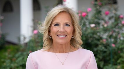 An image of Dr. Jill Biden. She is a woman with white skin, shoulder-length blonde hair, and she is wearing a pink shirt and smiling at the camera against an outdoor background. The header image leads to an article titled, "Milken Institute Launches New Women’s Health Network, Former First Lady Jill Biden Joins as its Chair".