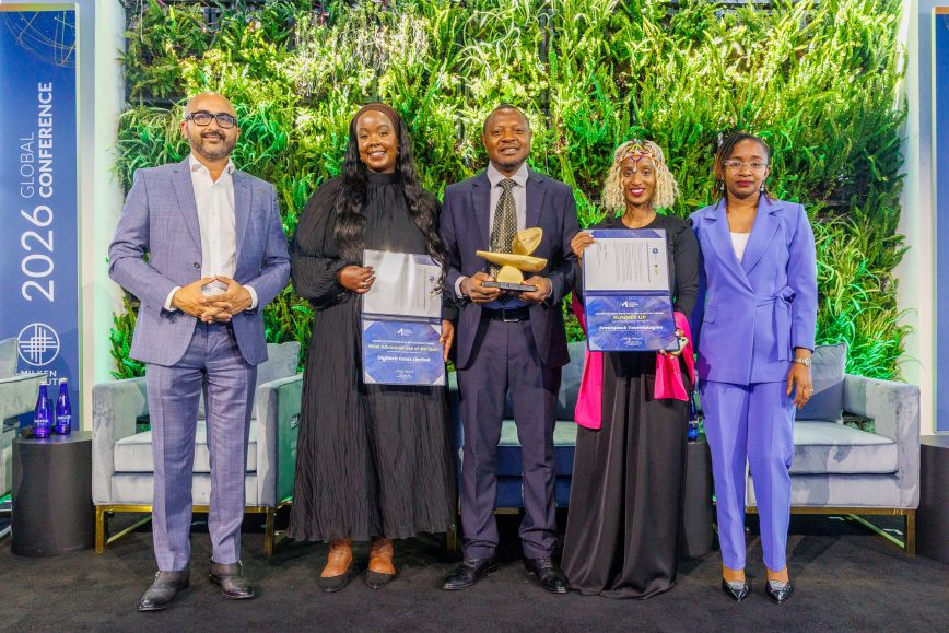 Five professionals holding certificates standing in a line outdoors under trees