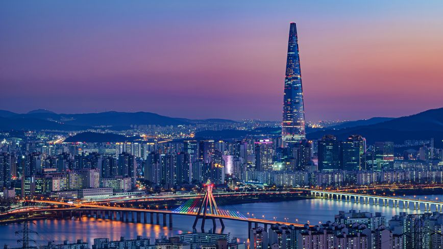view of city in south korea with pink and purple skies