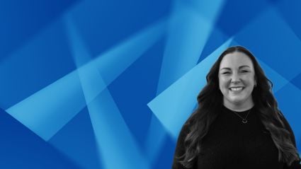 Smiling woman with long dark hair against abstract blue geometric background