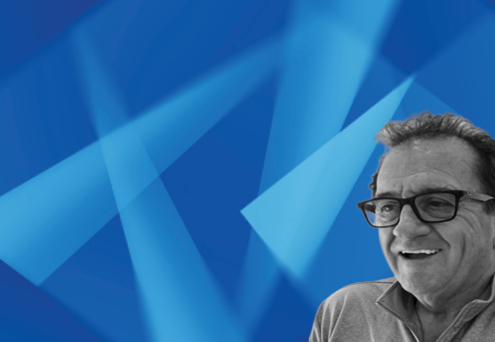 Man wearing glasses against blue geometric background
